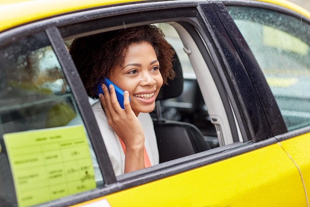 business trip transportation travel gesture people concept young smiling african american woman calling smartphone taxi city street 380164 120550